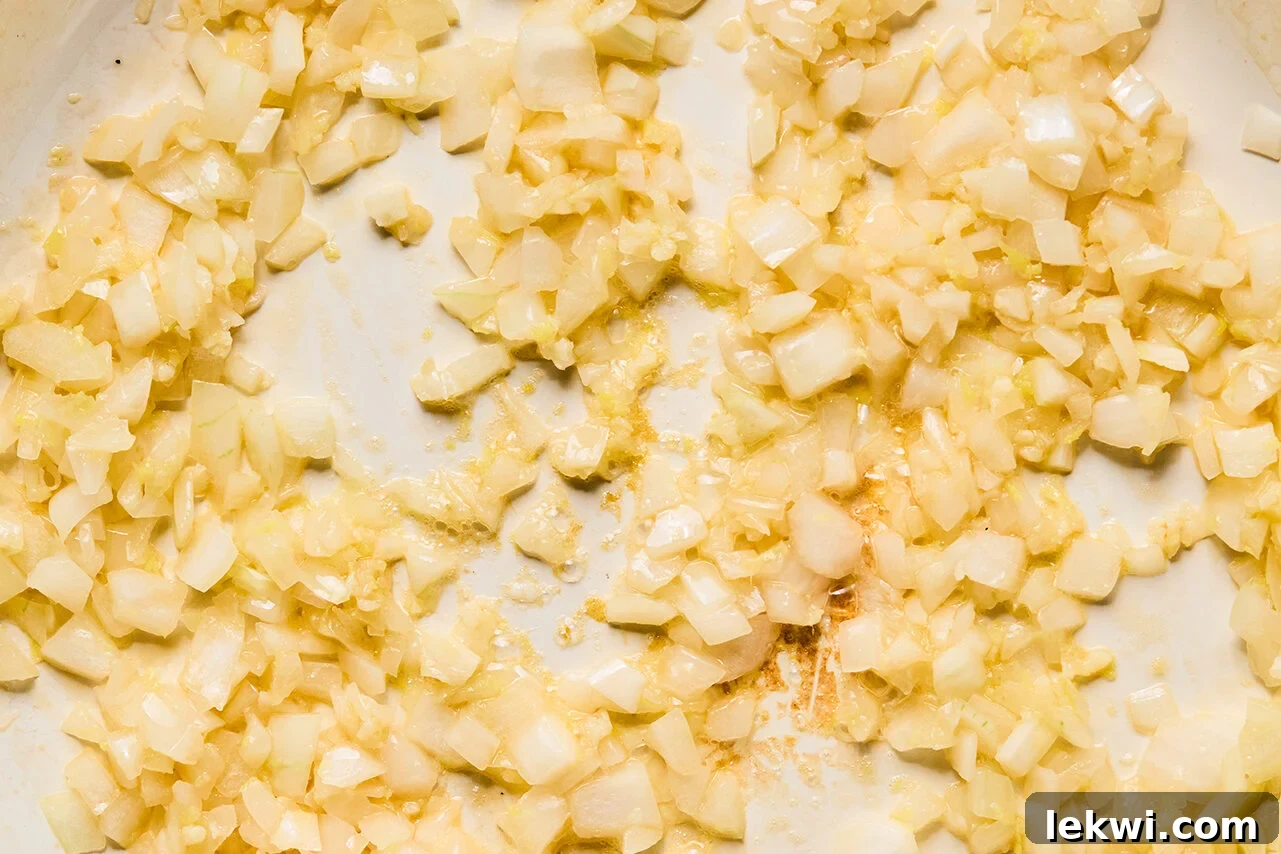 Onions, garlic, and ginger sauting in a pan.