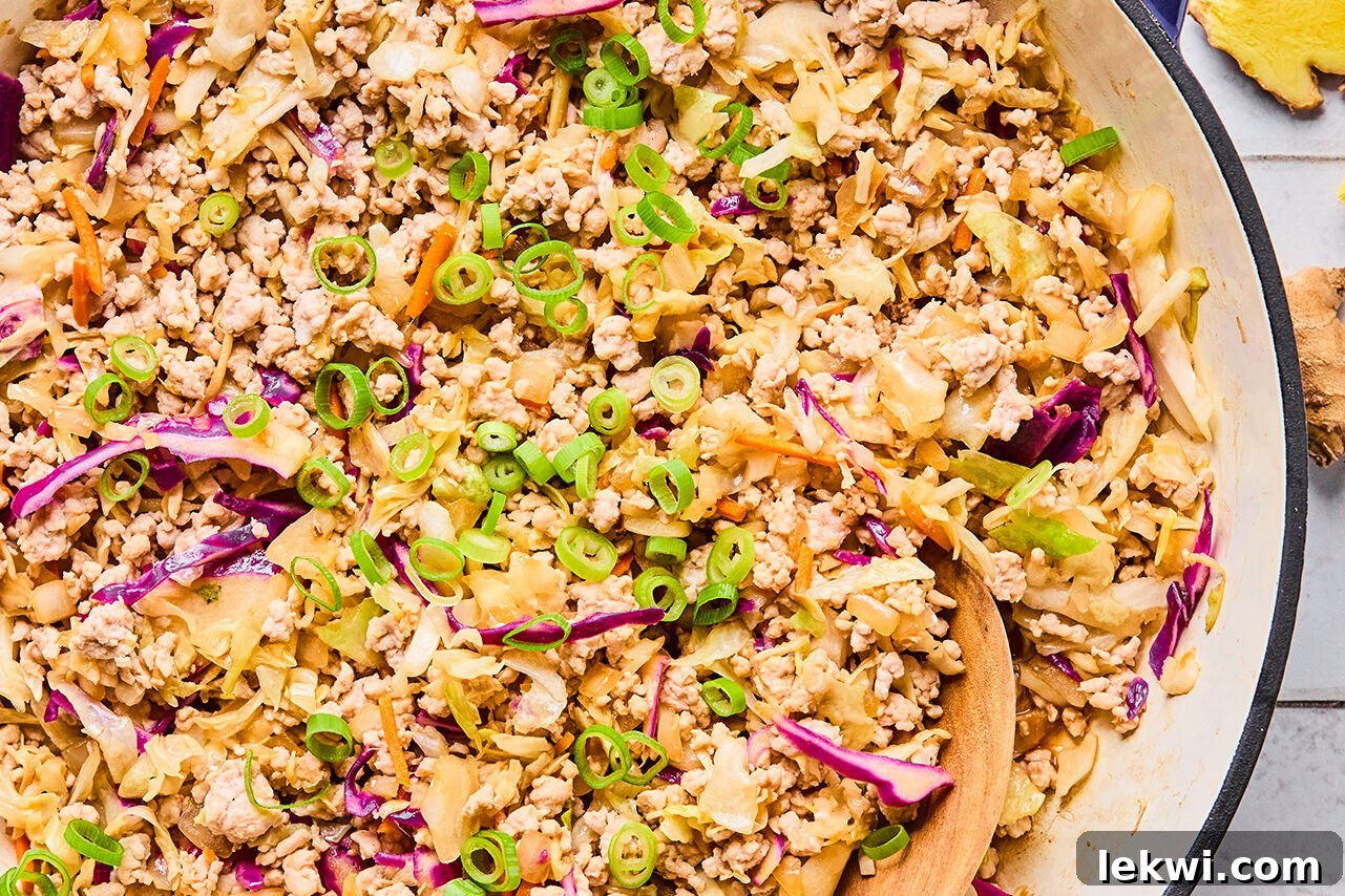 The finished egg roll in a bowl toped with green onions ready to be enjoyed!