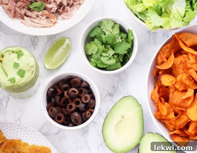 Close-up of a Paleo Nacho Bar with various ingredients in white bowls, suitable for Whole30 and AIP diets