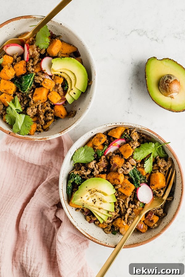 Two vibrant bowls of Mexican-inspired breakfast skillet, garnished and ready to eat.