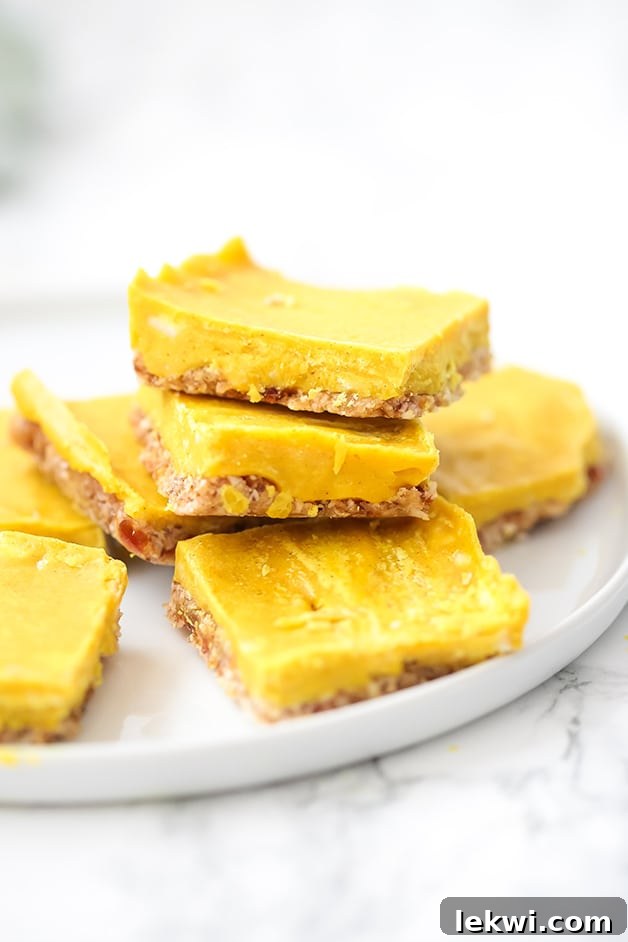 A white plate elegantly arranged with seven golden turmeric bars, inviting you to indulge in these healthy, anti-inflammatory treats.