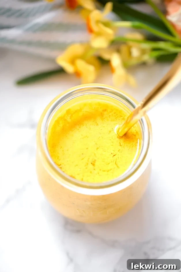 Vibrant Anti-inflammatory Turmeric Dressing in a glass jar, perfect for Paleo, AIP, Whole30 diets.