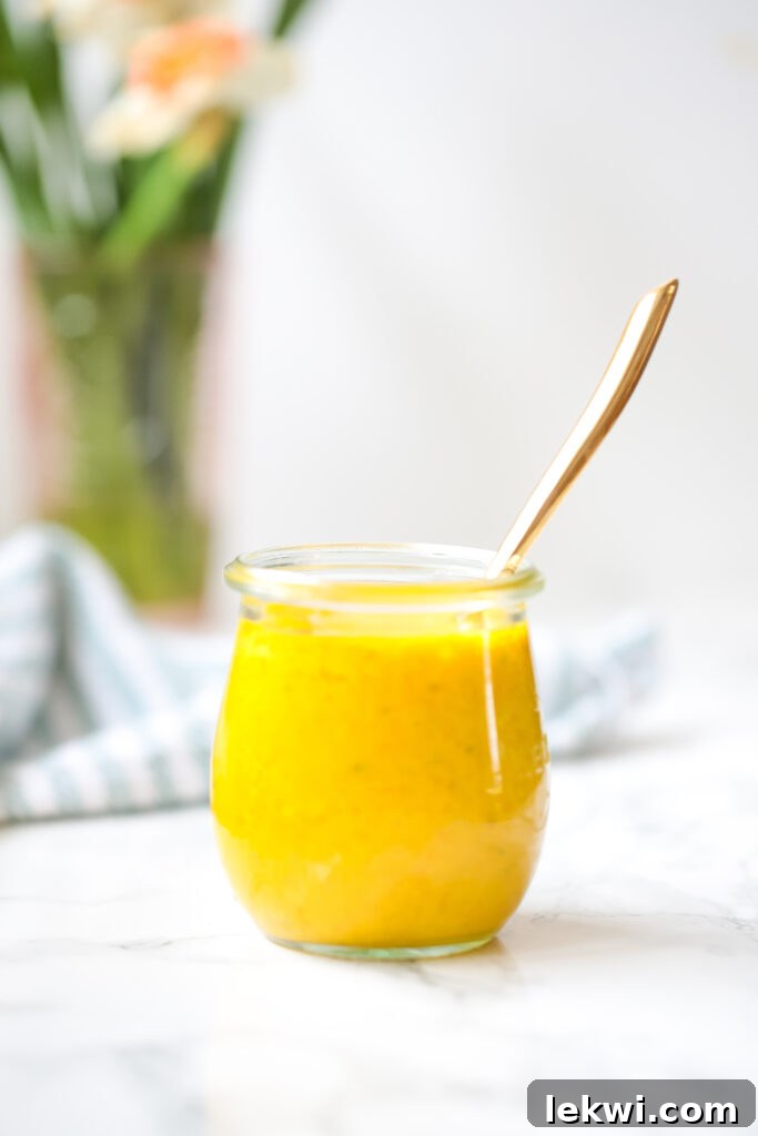 A second view of the golden Anti-inflammatory Turmeric Dressing, showcasing its vibrant color and creamy texture.