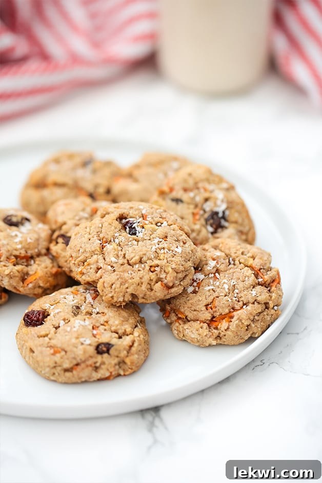 Delicious Paleo Carrot Cake Protein Cookies stacked on a plate, ready to be enjoyed as a healthy snack or dessert.