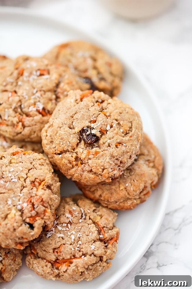 A beautifully arranged plate of Paleo Carrot Cake Protein Cookies, showcasing their golden-brown edges and soft centers.