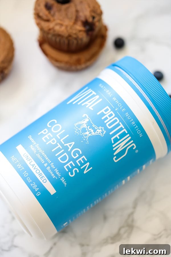 A cylindrical container of Vital Proteins Collagen Peptides rests on a kitchen counter, suggesting its presence as a key ingredient for healthy baking and daily wellness routines.