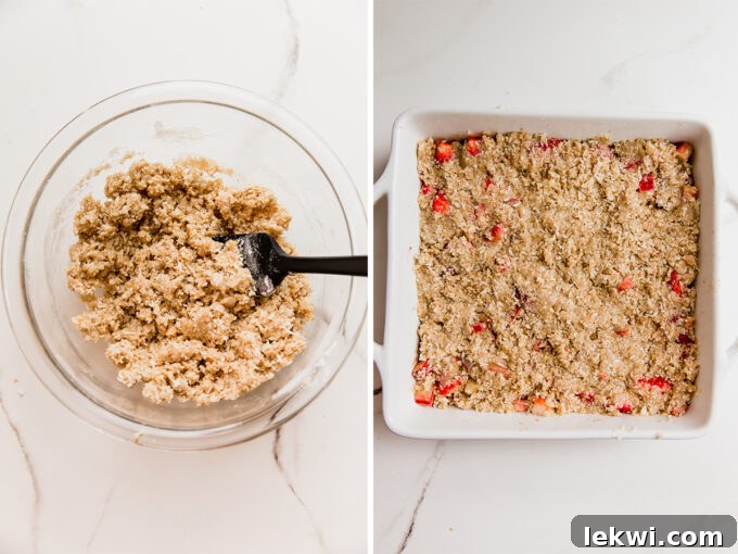 A baking dish filled with the colorful strawberry rhubarb fruit base, now expertly covered with the golden, crumbly crisp topping, signifying it's ready for the oven to transform it.