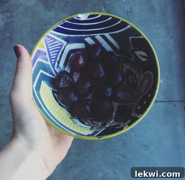 A bowl of vibrant frozen cherries, a sweet and refreshing treat to mark the end of summer on Labor Day.