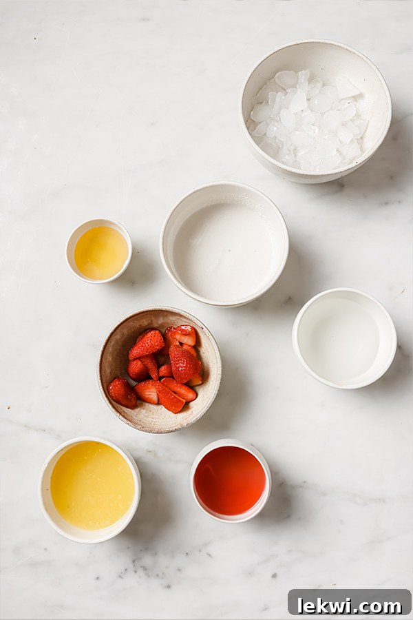 Ingredients including coconut cream, lemon juice, cranberry juice, frozen strawberries, and honey.