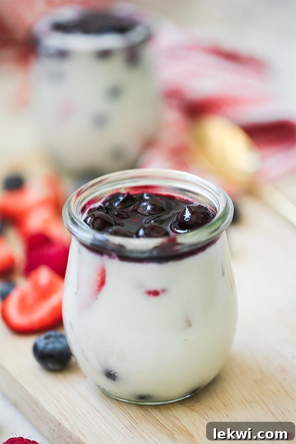 Red, White & Blue Berry Panna Cotta (Paleo, AIP, Dairy Free) showing the beautiful layers in a glass jar, ready to be served.