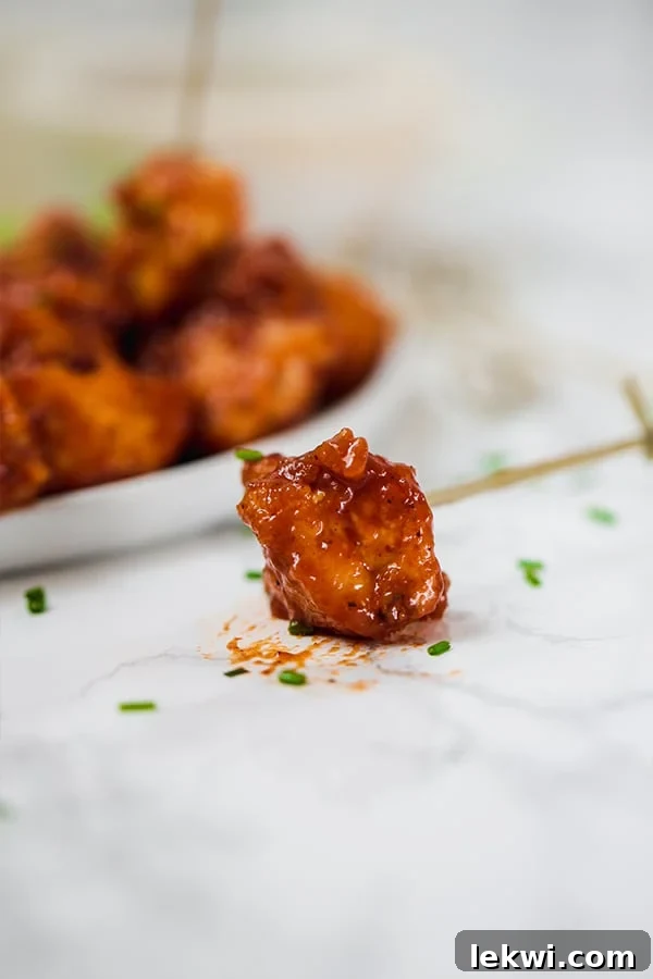 Appetizer setup with BBQ Chicken Poppers, dipping sauce, and fresh herbs