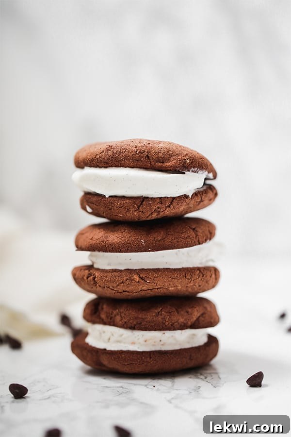 A stack of three homemade chocolate cookie ice cream sandwiches, a perfect summer treat.