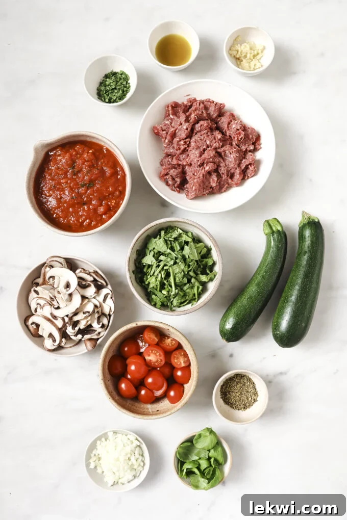 Ingredients for lasagna skillet including mushrooms, spinach, and zucchini.