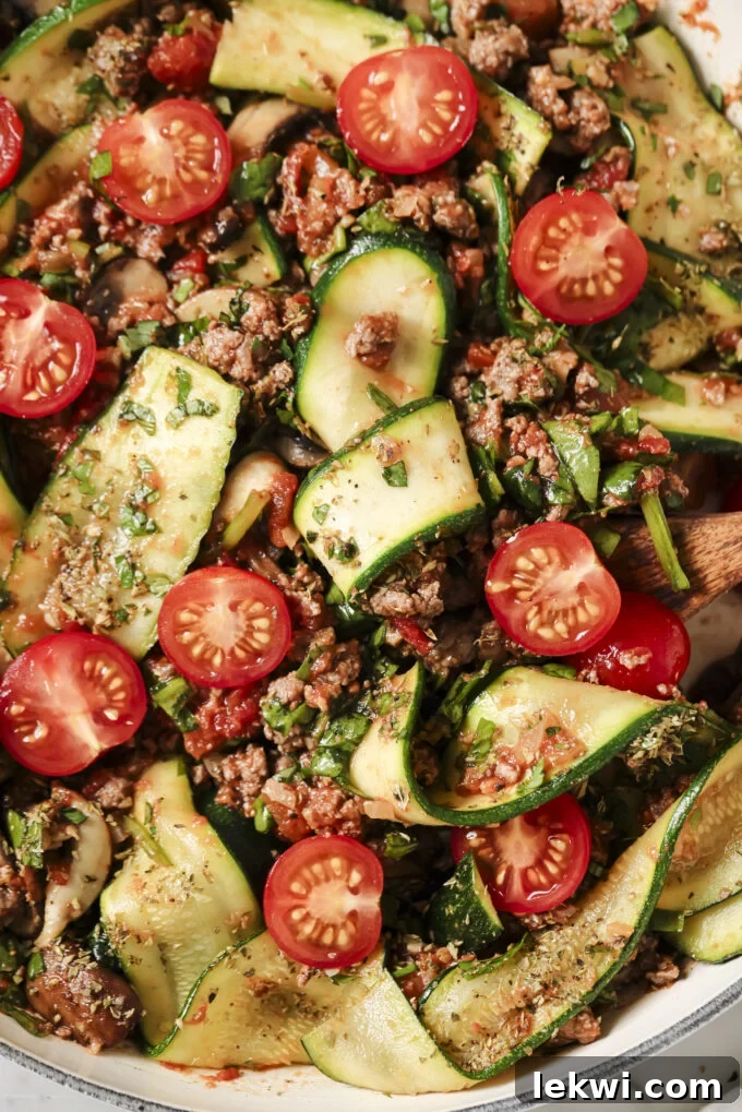 Wooden spoon in a pan of lasagna skillet.