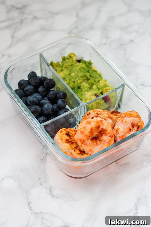 Sweet potato chicken poppers packed with berries and guacamole for a paleo lunch.