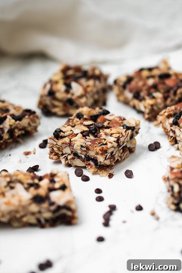 Several homemade Paleo Granola Bars laid out on a kitchen counter, ready to be enjoyed as healthy, energy-boosting snacks.