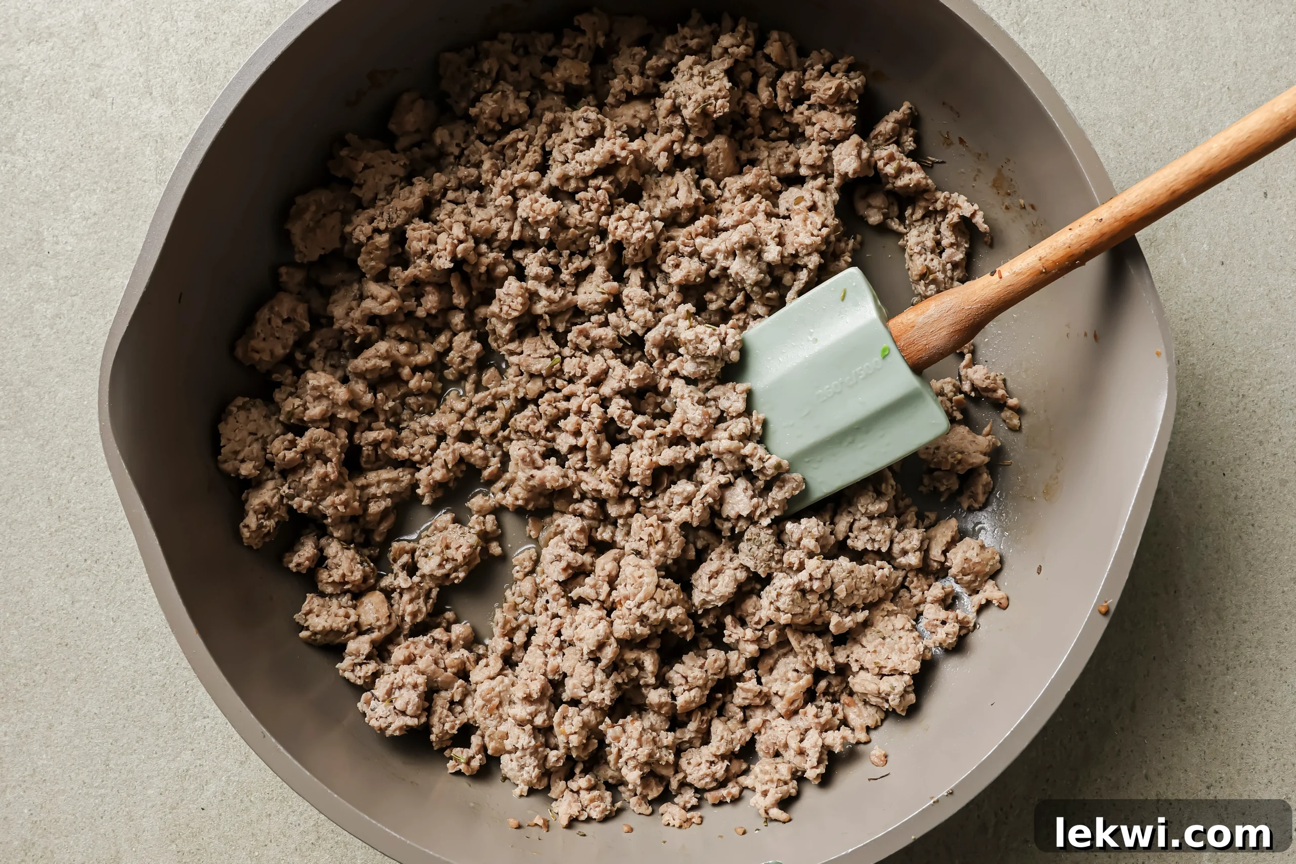 The ground turkey browning in a pan, seasoned with herbs.