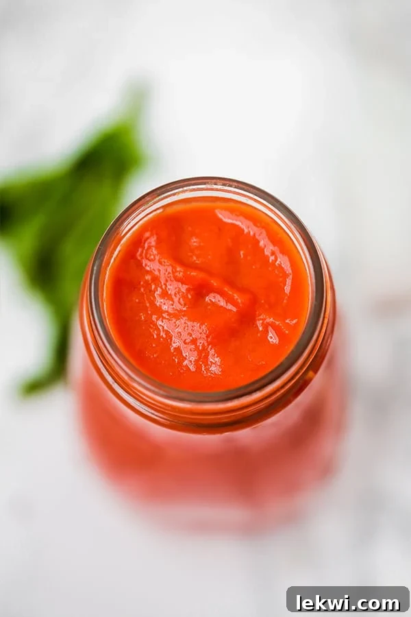 A view from above of glass jar filled with nightshade free marinara sauce.