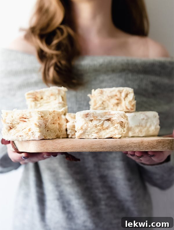 Close-up of a grain free rice crispy treat, showing the marshmallow and toasted coconut texture.