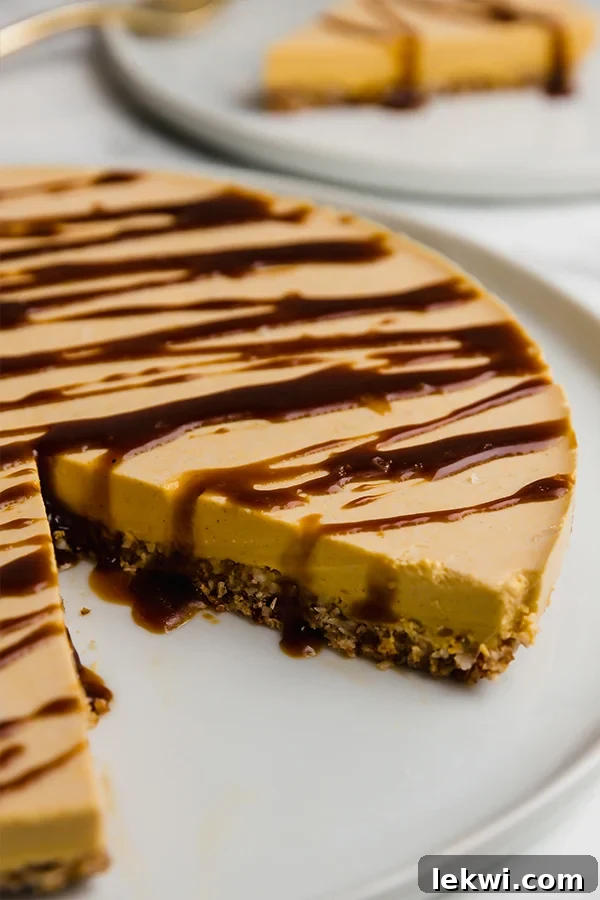 An elegant pumpkin cheesecake on a pristine white plate, with a perfect slice removed to reveal its creamy texture and golden hue, ready to be served, making it a centerpiece dessert.