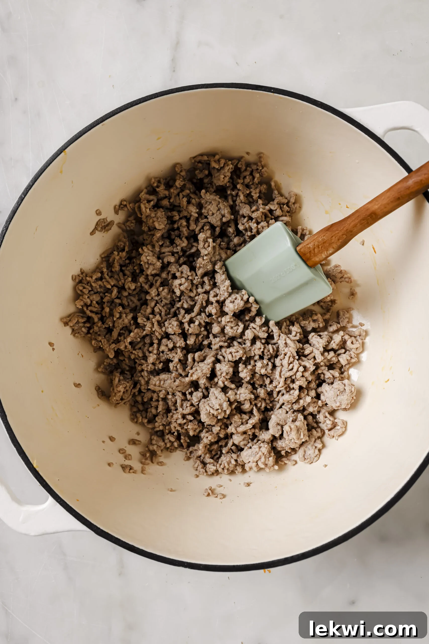 Cooked pork crumbled in a pot.