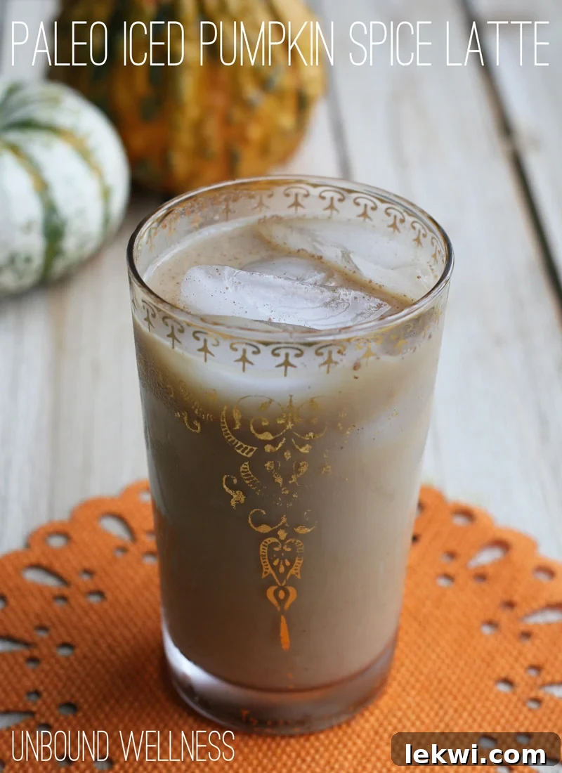 Iced pumpkin spice latte in a white and gold glass 