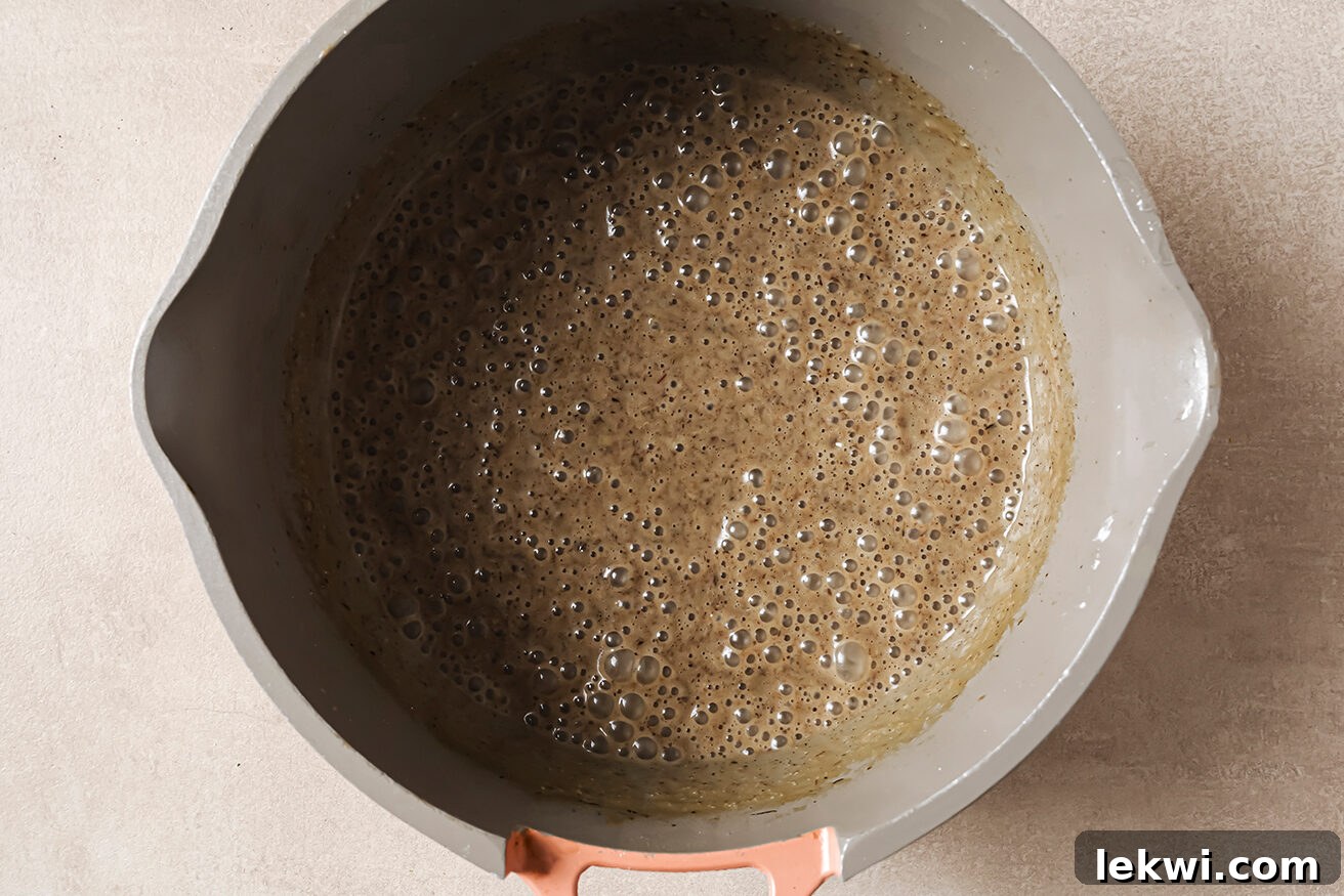 Cream of mushroom soup, fully blended to a smooth consistency, in a pot.