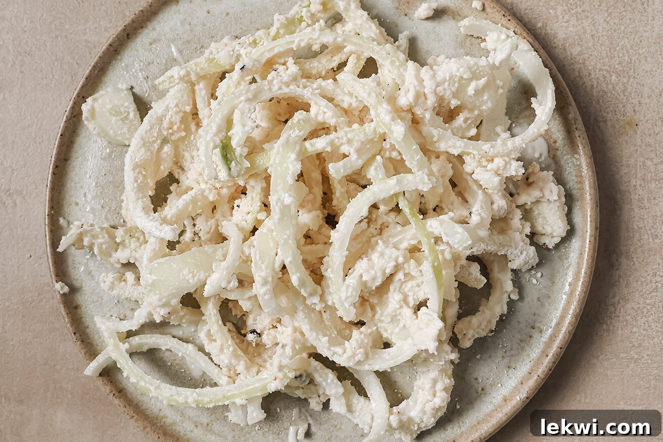 Thinly sliced onions tossed in a gluten-free batter, ready to be fried.