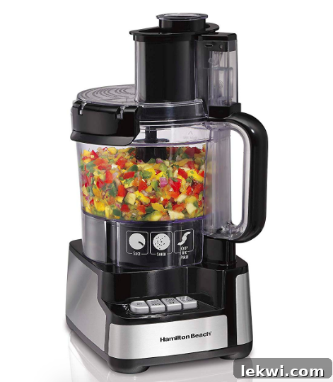 A food processor filled with colorful vegetables, ready for chopping and blending.