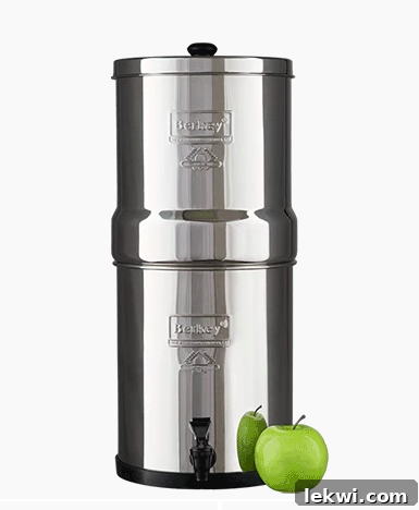 A Berkey water filter with a fresh apple next to it, symbolizing purity and health.