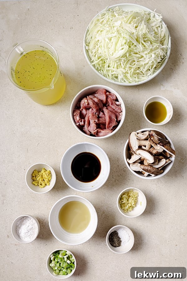 All the fresh ingredients for homemade hot & sour soup laid out on a wooden cutting board before cooking.