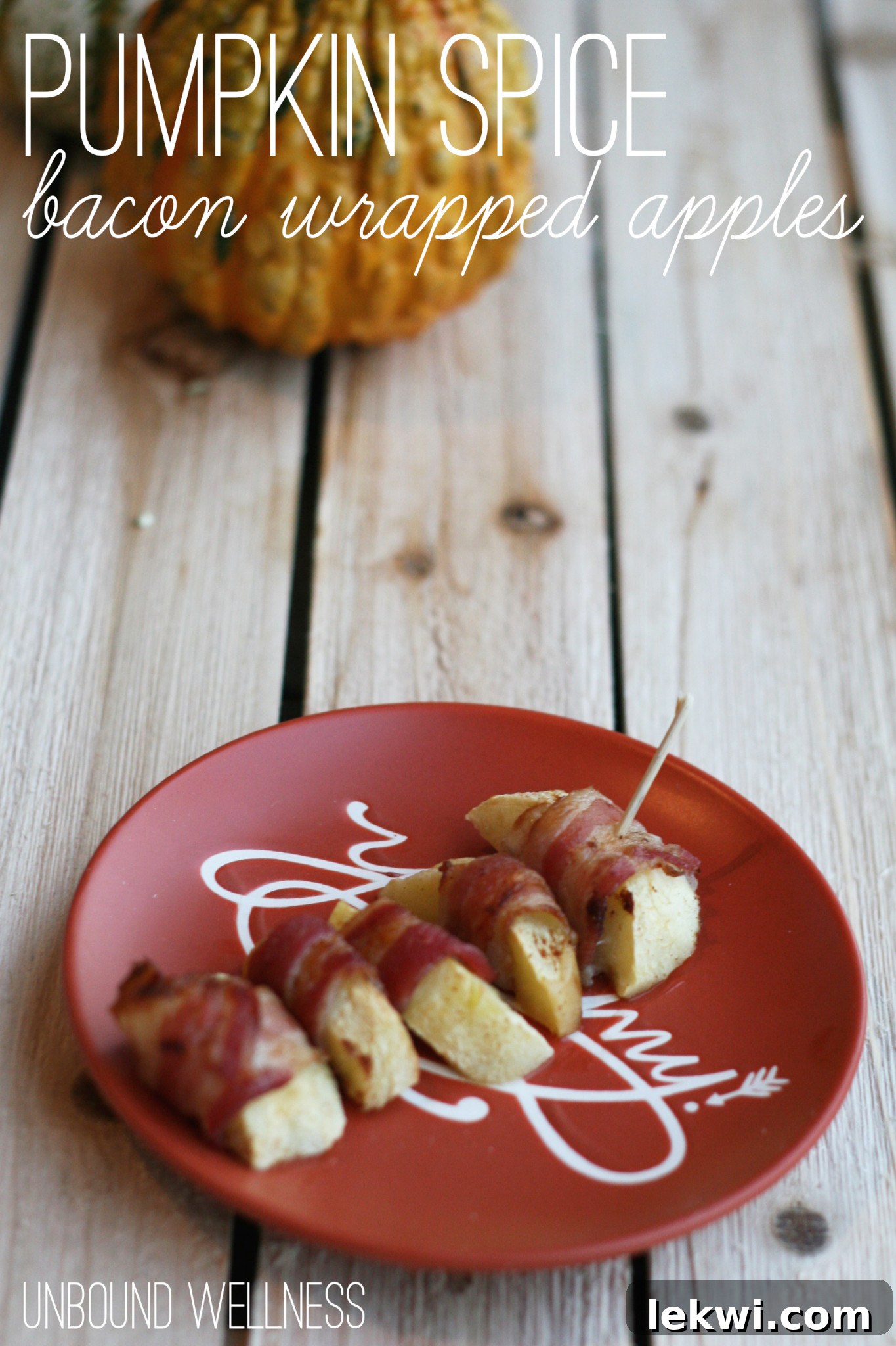 Crispy Pumpkin Spice Bacon Wrapped Apple slices, beautifully presented on a dark wooden board with fall foliage in the background, ready to be enjoyed.