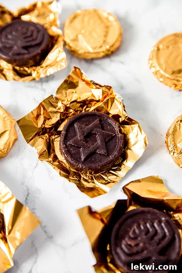 A golden-wrapped Hanukkah gelt coin resting amongst several others, inviting a taste.
