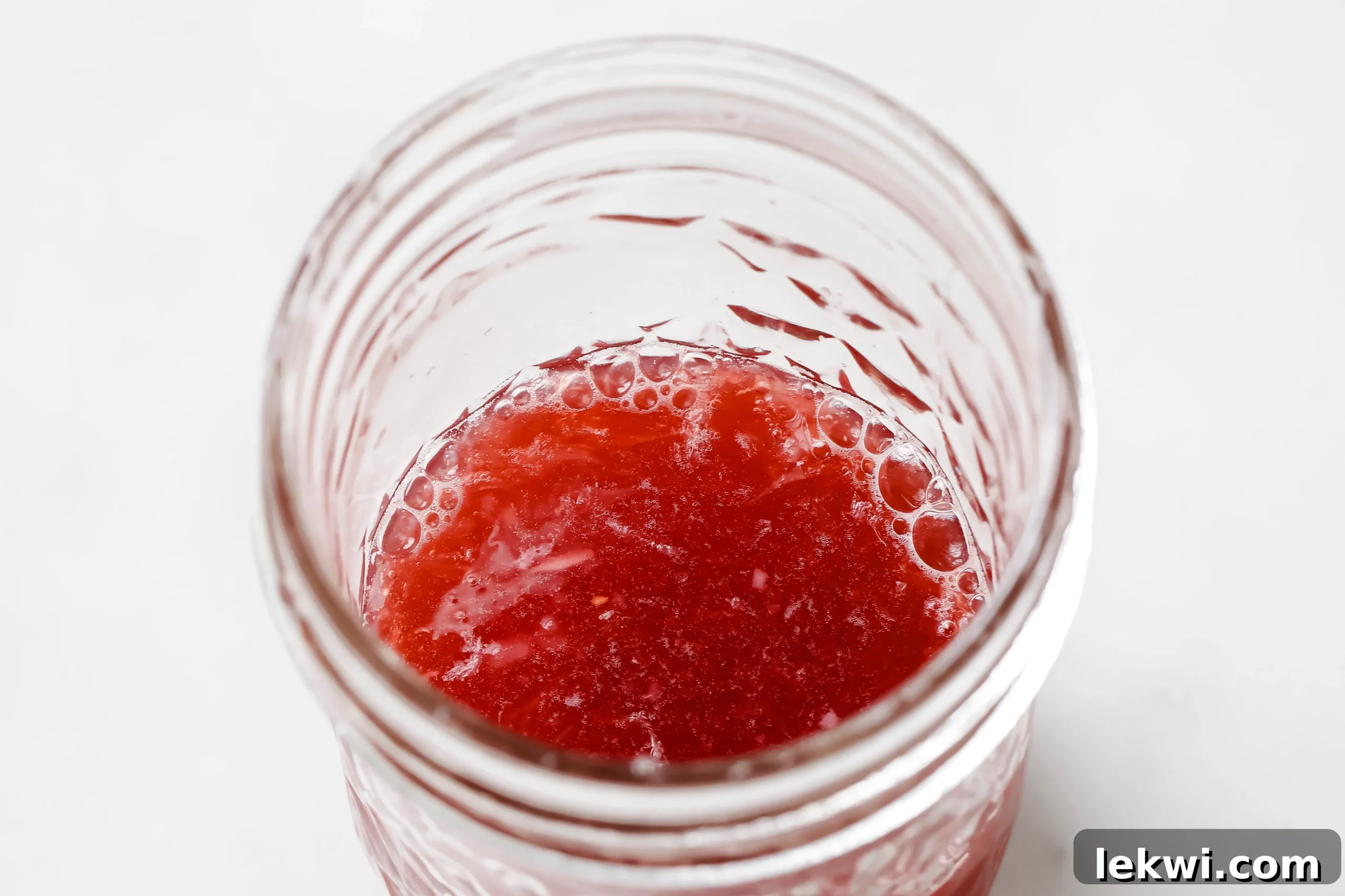 Small glass jars filled with different flavored apple cider vinegar shot mixes, securely lidded and ready for refrigeration.