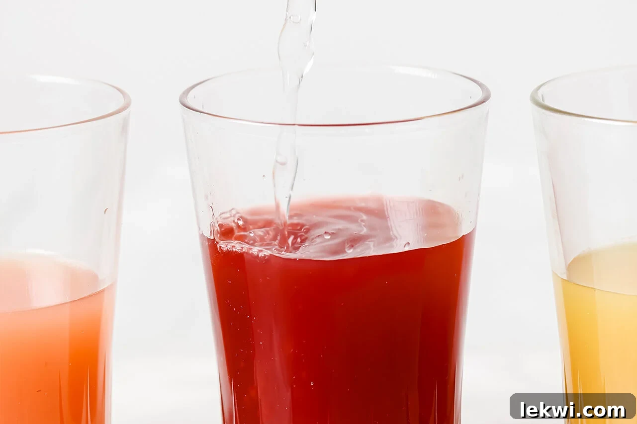 An apple cider vinegar shot in a glass, with sparkling water being poured in for proper dilution, highlighting a key safety step.