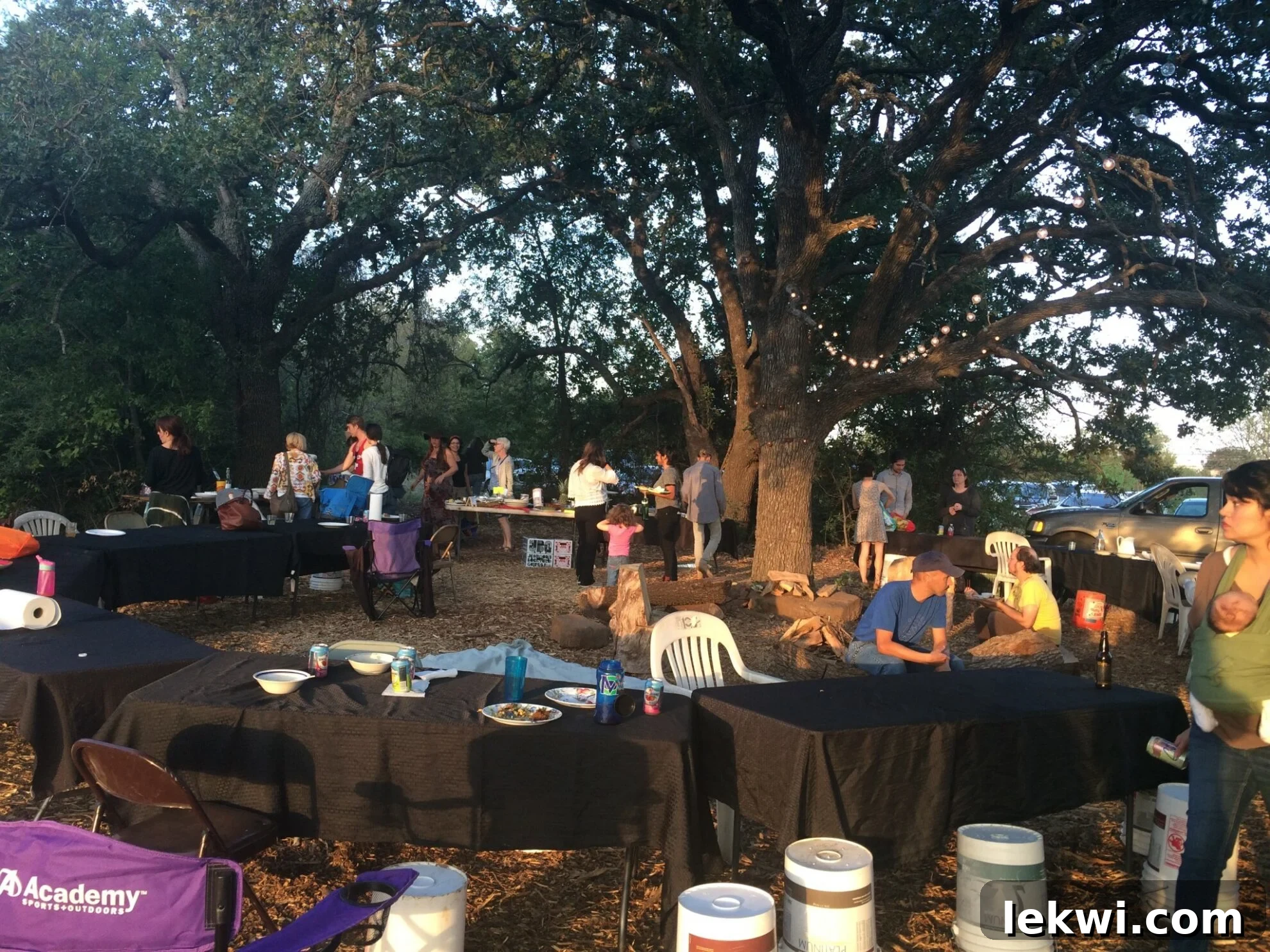 Autumn Harvest: Johnson's Organic Garden Tour and Potluck 2 Guests gather at Johnson's Backyard Garden potluck with dishes to share.