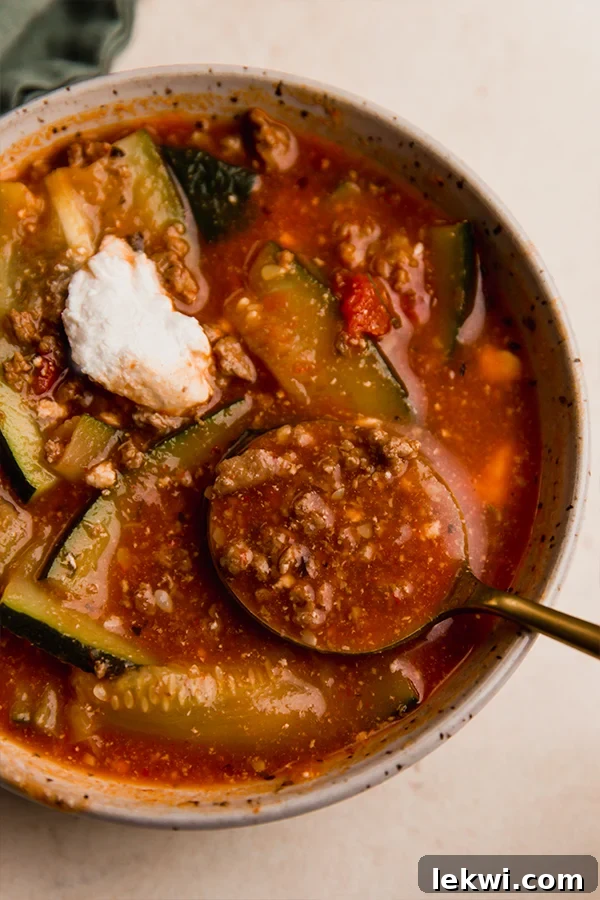 Bowl of lasagna soup with a spoon.