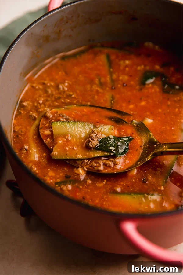 Pot of lasagna soup with a spoon.