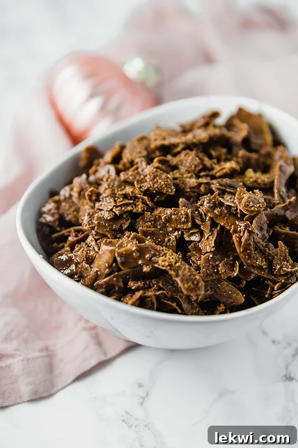 A white bowl filled with paleo coconut puppy chow.
