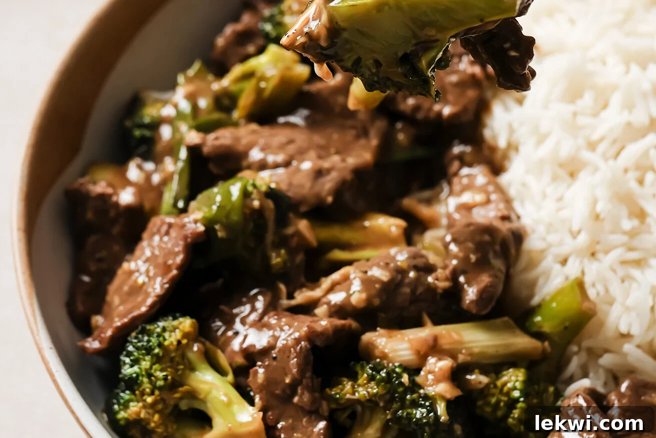 A serving of gluten-free Mongolian beef with broccoli on a plate, ready to eat.
