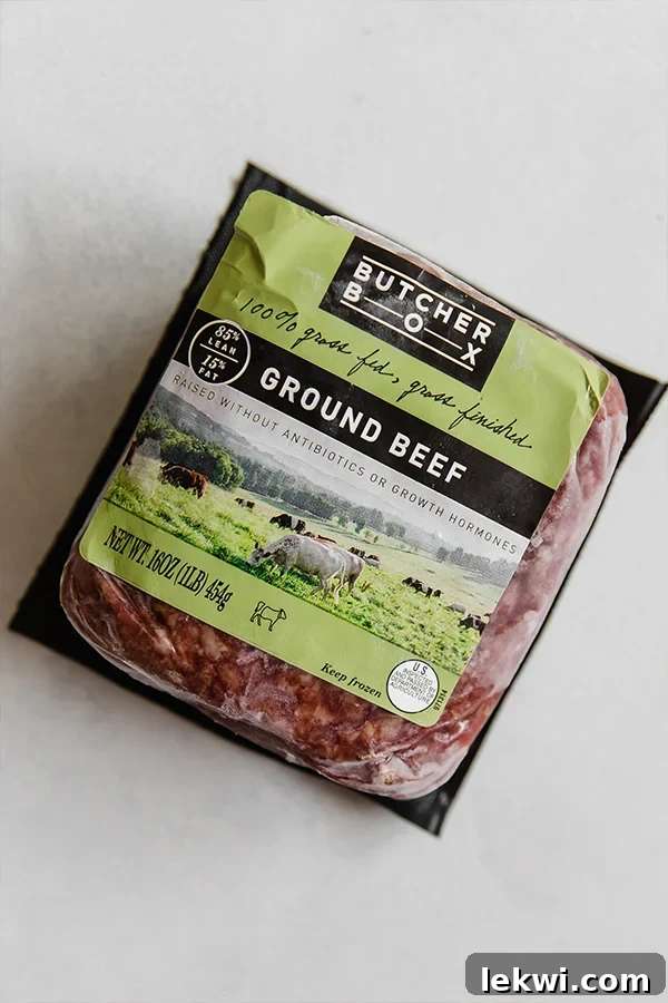 A vacuum-sealed package of frozen ButcherBox ground beef, clearly labeled and ready for storage or thawing, sitting on a kitchen counter.