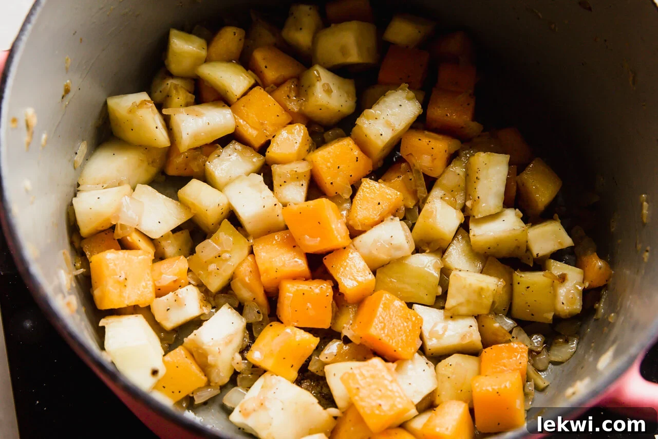 Diced onions and garlic sautéing in avocado oil in a pot.