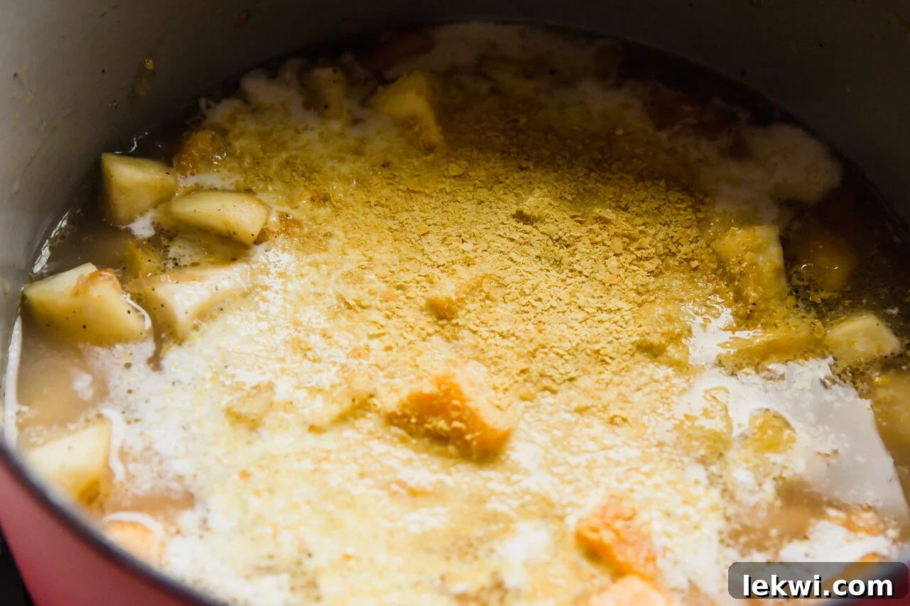 All vegan queso ingredients in a pot, simmering gently.