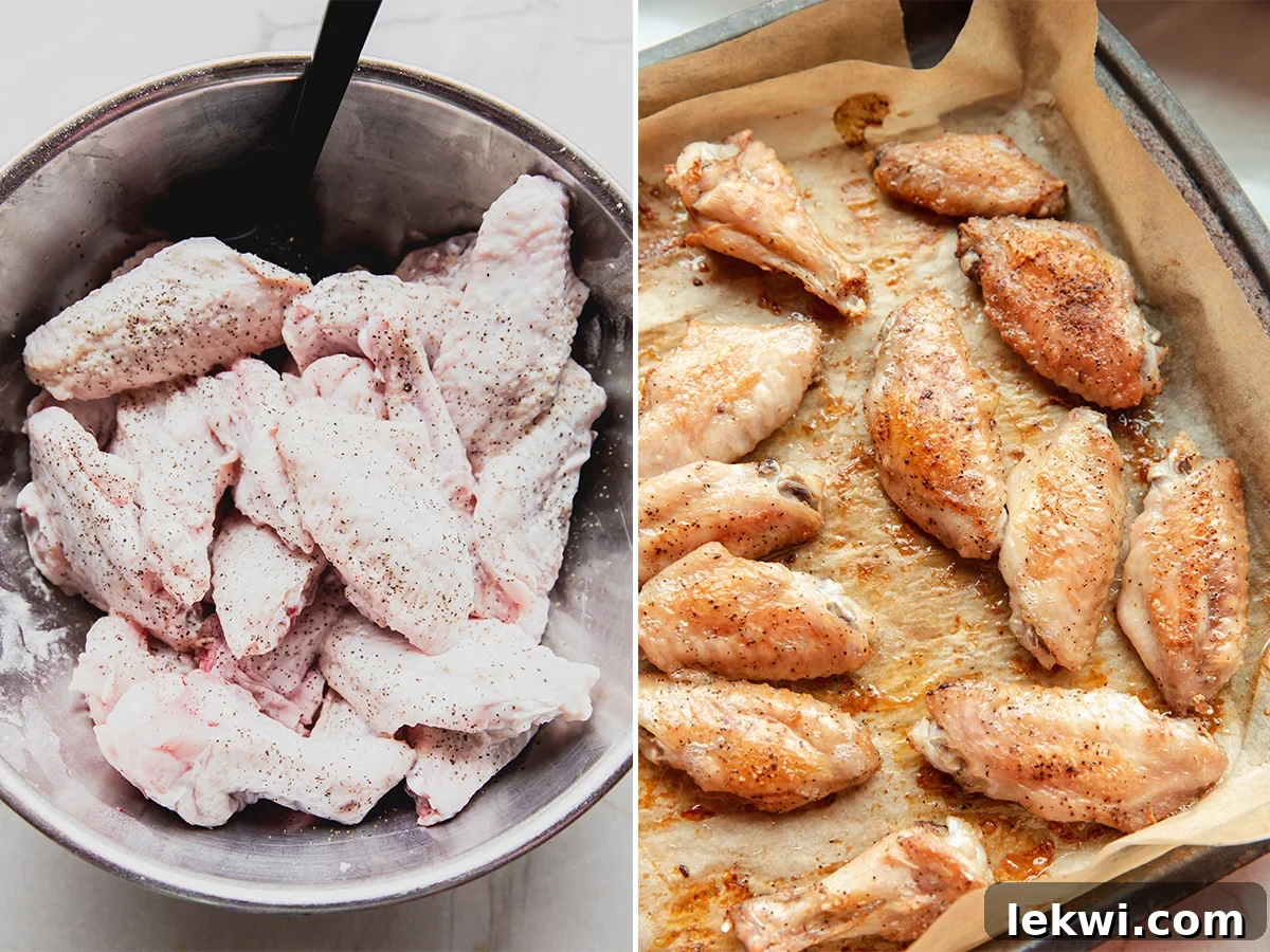 Seasoned chicken wings coated with baking powder and arrowroot starch, laid out on a parchment-lined baking sheet, ready for baking.