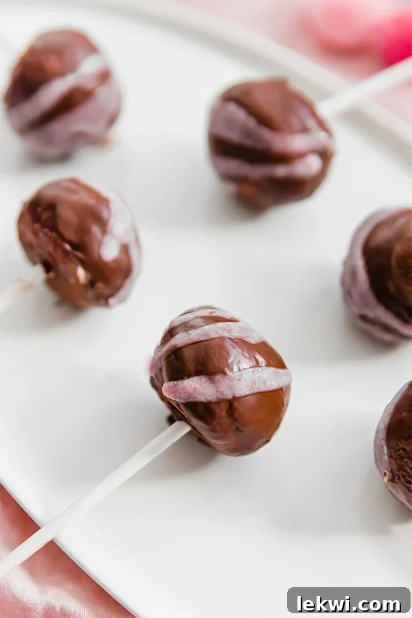 Two vibrant no-bake cake pops, showcasing their delicious texture and coating.