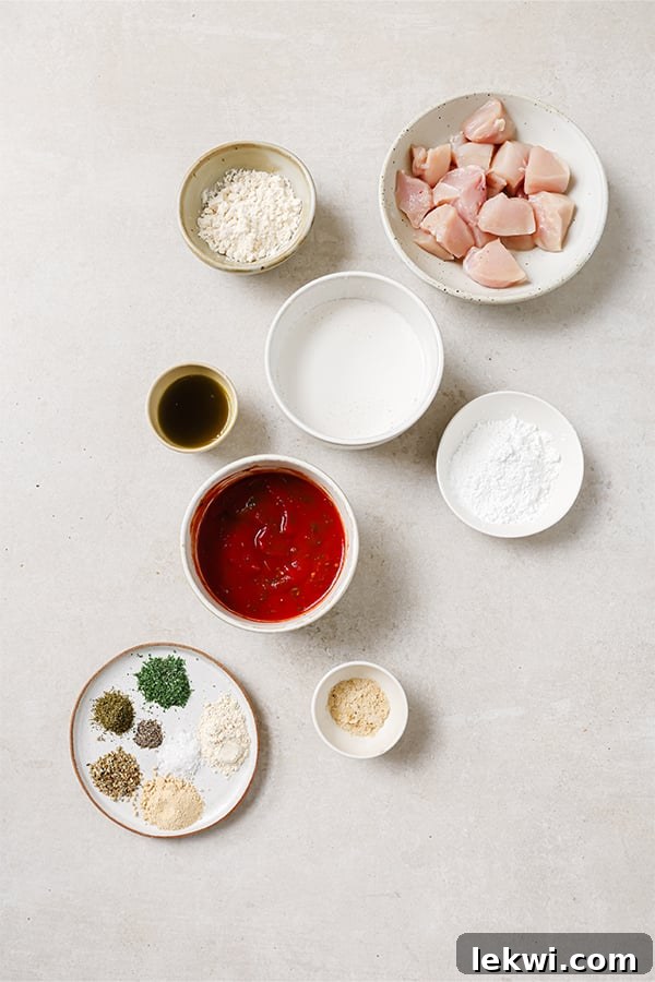 Close-up of ingredients including coconut milk, arrowroot starch, coconut flour, nutritional yeast, and various Italian herbs.