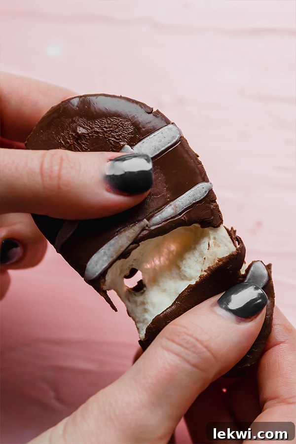 A perfectly folded homemade marshmallow Easter egg, highlighting its fluffy texture and chocolate coating.