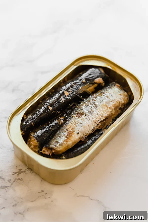 A close-up of a simple sardine salad with fresh ingredients.