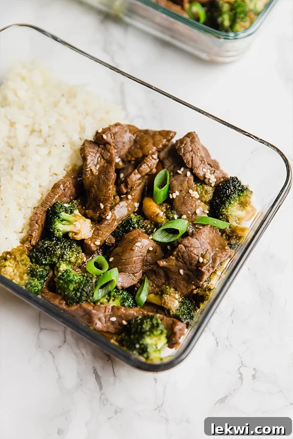 A glass meal prep container with cauliflower rice and beef and broccoli.