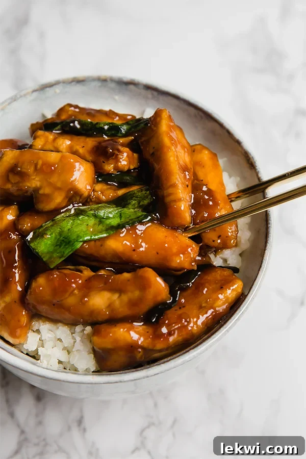 Mongolian Chicken stir-fried to perfection, showcasing its rich sauce and fresh green onions.